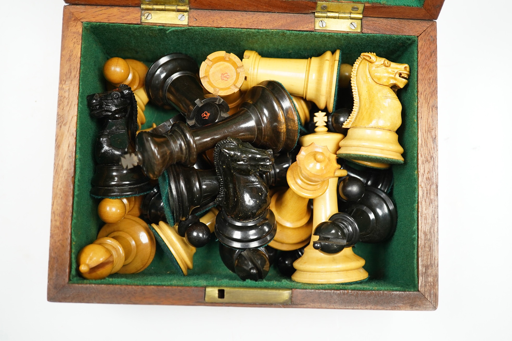 A boxed Jaques Staunton boxwood and ebonised lead weighted chess set, White king stamped Jaques London, Kings 10cm, unlabelled box 20cm wide x 9cm high. Condition - chess pieces good, box cracked